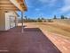 View of a large backyard and covered patio featuring a red brick paver hardscape and block wall at 3702 E Karen Dr, Phoenix, AZ 85032