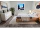 A well-lit bedroom with neutral tones featuring modern furniture and a bright window at 3702 E Karen Dr, Phoenix, AZ 85032