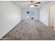 Neutral carpeted bedroom with ceiling fan and sliding doors leading to outdoor space at 3702 E Karen Dr, Phoenix, AZ 85032