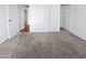 Spacious bedroom features neutral carpet, closet and a view to another room at 3702 E Karen Dr, Phoenix, AZ 85032