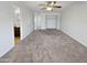 Spacious bedroom with neutral carpet, ceiling fan, and doorways to other rooms at 3702 E Karen Dr, Phoenix, AZ 85032