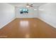 Empty living room with neutral walls and hardwood floors featuring a window to the outside at 3702 E Karen Dr, Phoenix, AZ 85032