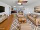 Spacious living room with hardwood floors, a ceiling fan, and modern neutral-toned furniture at 3702 E Karen Dr, Phoenix, AZ 85032