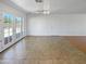 Well-lit living room with light tile flooring and views of the backyard through glass doors at 3702 E Karen Dr, Phoenix, AZ 85032