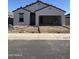 A single-story stucco house with an attached two-car garage featuring a tiled roof and low water use landscaping at 3945 E San Jose St, San Tan Valley, AZ 85143