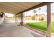 This backyard features a pool, a lush green lawn, and a shaded patio area at 4038 E Wescott Dr, Phoenix, AZ 85050
