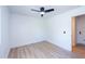 This bedroom includes wood grain flooring, white trim, and a modern ceiling fan at 4038 E Wescott Dr, Phoenix, AZ 85050