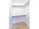 This walk-in closet features custom organizers and wood grain flooring at 4038 E Wescott Dr, Phoenix, AZ 85050