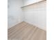 This walk-in closet features custom organizers and wood grain flooring at 4038 E Wescott Dr, Phoenix, AZ 85050