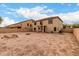 Large backyard featuring a fence, a fire pit, and a house in the background at 43724 W Cowpath Rd, Maricopa, AZ 85138