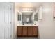 This bathroom has double sinks, a large mirror, and good lighting at 43724 W Cowpath Rd, Maricopa, AZ 85138