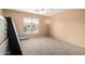 Bedroom with neutral walls and carpet features a window for natural light and a ceiling fan at 43724 W Cowpath Rd, Maricopa, AZ 85138
