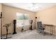 Bedroom space with large window allowing natural light, ceiling fan, and furnishings to create a recording studio at 43724 W Cowpath Rd, Maricopa, AZ 85138
