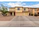 Inviting two-story home with a spacious three-car garage and well-maintained desert landscaping at 43724 W Cowpath Rd, Maricopa, AZ 85138