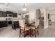 Open kitchen featuring black cabinetry, stainless steel appliances, an island and dining space with seating for four at 43724 W Cowpath Rd, Maricopa, AZ 85138