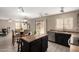 Open kitchen featuring black cabinetry, stainless steel appliances, an island and dining space with seating for four at 43724 W Cowpath Rd, Maricopa, AZ 85138