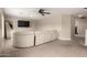 Relaxing living area features an entertainment center with a large, comfortable white sofa at 43724 W Cowpath Rd, Maricopa, AZ 85138