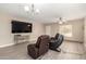 Comfortable living room featuring plush leather seating, neutral walls, and stylish ceiling fan at 43724 W Cowpath Rd, Maricopa, AZ 85138