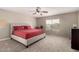 Spacious main bedroom with neutral carpet, ceiling fan, and lots of light at 43724 W Cowpath Rd, Maricopa, AZ 85138