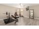 Dedicated home gym space with weightlifting equipment and ample natural light from two windows at 43724 W Cowpath Rd, Maricopa, AZ 85138