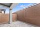 Private backyard showcasing a paved patio area, perfect for entertaining, surrounded by brick walls at 4383 N 203Rd Dr, Buckeye, AZ 85396
