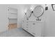 Stylish bathroom featuring a double vanity, modern fixtures, and a spacious walk-in closet at 4383 N 203Rd Dr, Buckeye, AZ 85396