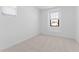 Minimalist bedroom offers neutral carpet and a sunny window at 4383 N 203Rd Dr, Buckeye, AZ 85396