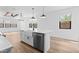Bright kitchen with a large island, stainless steel appliances, and modern pendant lighting at 4383 N 203Rd Dr, Buckeye, AZ 85396