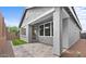 Charming backyard patio featuring a covered porch, neat landscaping, and durable pavers at 4383 N 203Rd Dr, Buckeye, AZ 85396