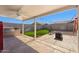 Covered patio featuring a built-in grill and seating area overlooking backyard at 4407 E Meadow West Ln, Queen Creek, AZ 85140