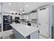 Modern kitchen featuring white cabinets, stainless steel appliances, a center island and dark accents at 4407 E Meadow West Ln, Queen Creek, AZ 85140