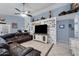 Stylish living room featuring a comfortable leather sofa, ceiling fan, and decorative accent wall at 4407 E Meadow West Ln, Queen Creek, AZ 85140