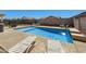 Sparkling pool with waterfall feature, surrounded by desert landscaping and lounge chairs at 4407 E Meadow West Ln, Queen Creek, AZ 85140