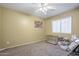 Minimalist bedroom featuring a ceiling fan, window, and soft carpet flooring at 4415 W Ellis St, Laveen, AZ 85339