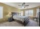 Spacious bedroom featuring a ceiling fan, large window, and a cozy bed with storage drawers at 4415 W Ellis St, Laveen, AZ 85339