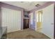 Bedroom features neutral carpet, mauve walls, closet, and white trim at 4415 W Ellis St, Laveen, AZ 85339