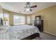 Serene bedroom featuring a ceiling fan, a large bed, and neutral tones at 4415 W Ellis St, Laveen, AZ 85339