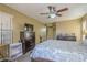 This bedroom offers a cozy space with a ceiling fan, dresser, and neutral walls at 4415 W Ellis St, Laveen, AZ 85339