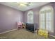 Cozy bedroom features neutral carpet, mauve walls, plantation shutters, and ceiling fan at 4415 W Ellis St, Laveen, AZ 85339