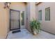A welcoming covered front entrance featuring a decorative security door and a potted plant at 4415 W Ellis St, Laveen, AZ 85339