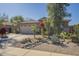 Inviting home featuring desert landscaping with decorative rocks and drought-tolerant plants with a two-car garage at 4415 W Ellis St, Laveen, AZ 85339