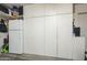 Garage featuring a refrigerator and wall of custom white storage cabinets at 4415 W Ellis St, Laveen, AZ 85339