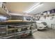 Spacious garage featuring two parked vehicles and ample overhead storage shelves at 4415 W Ellis St, Laveen, AZ 85339