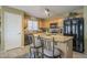 Traditional eat-in kitchen with granite countertops, black appliances, and a tile backsplash at 4415 W Ellis St, Laveen, AZ 85339