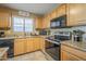 Well-lit eat-in kitchen with black appliances and neutral color palette at 4415 W Ellis St, Laveen, AZ 85339