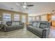 Bright living area with tile floors and comfortable gray couches, flowing into the dining area at 4415 W Ellis St, Laveen, AZ 85339