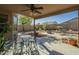 Covered patio with seating area and lush landscaping at 4415 W Ellis St, Laveen, AZ 85339