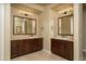 Double vanity bathroom featuring granite countertops and dark stained cabinets at 5641 E Grovers Ave, Scottsdale, AZ 85254