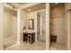 Primary bathroom featuring vanity, walk-in closet, and walk-in shower at 5641 E Grovers Ave, Scottsdale, AZ 85254