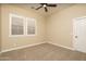 Light-filled bedroom with neutral carpet, plantation shutters, and ceiling fan at 5641 E Grovers Ave, Scottsdale, AZ 85254